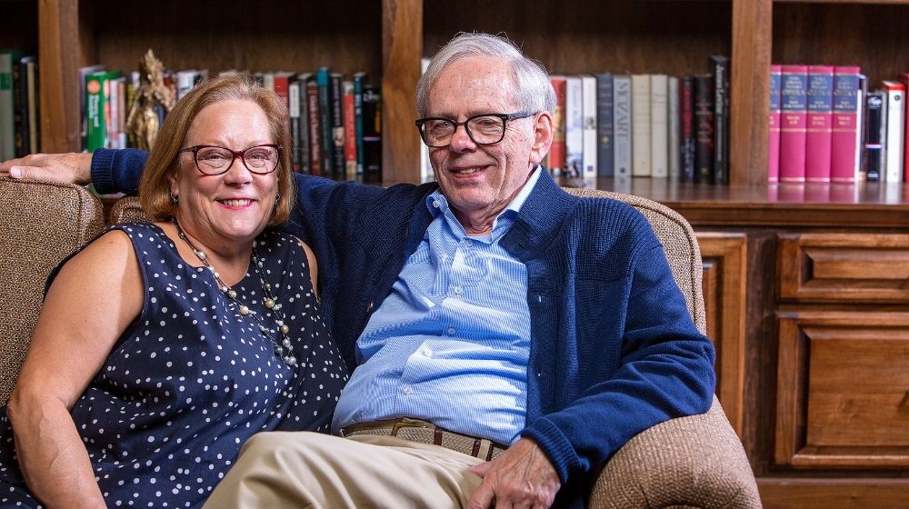 Karen and Bob Desjardins sitting on couch
